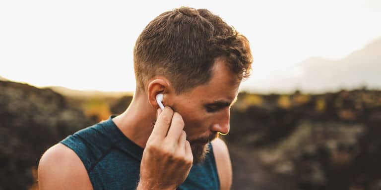 Man with wireless earbuds outdoor