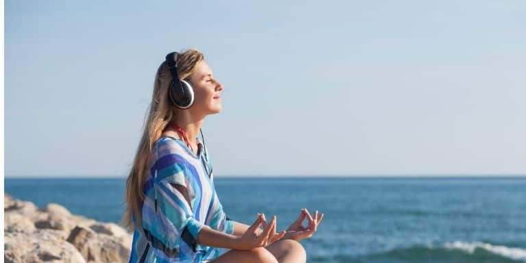 Woman meditating with over-ear headphones