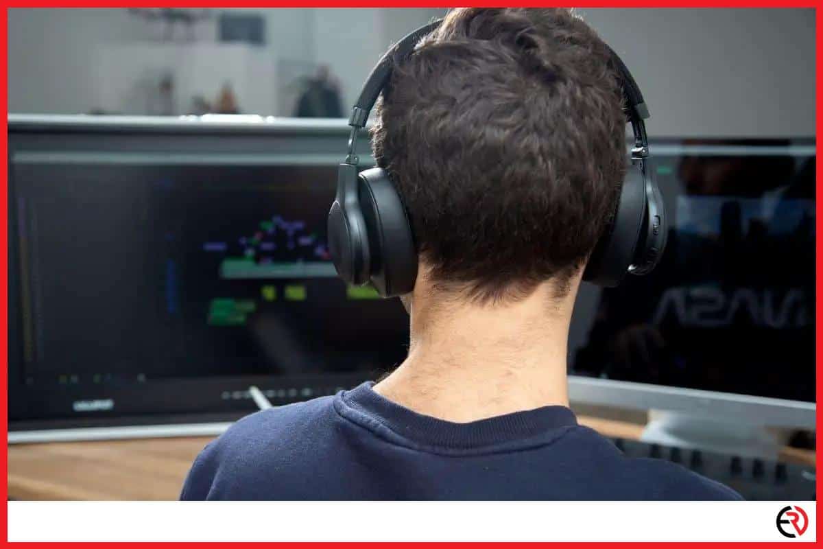 A man with wireless headset playing a game on the PC