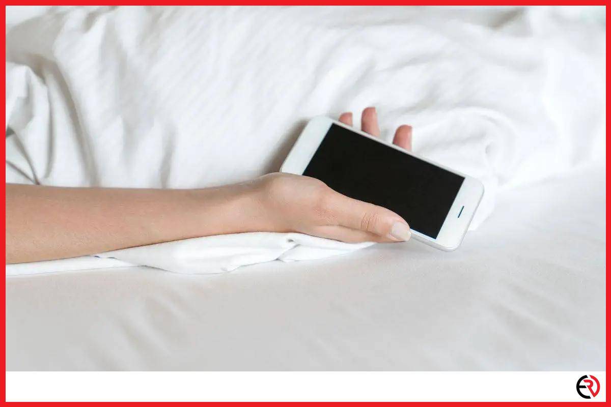 Woman sleeping with smartphone in her hand