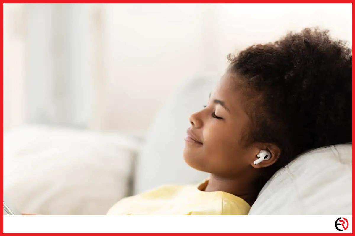 Woman sleeping with wireless earbuds