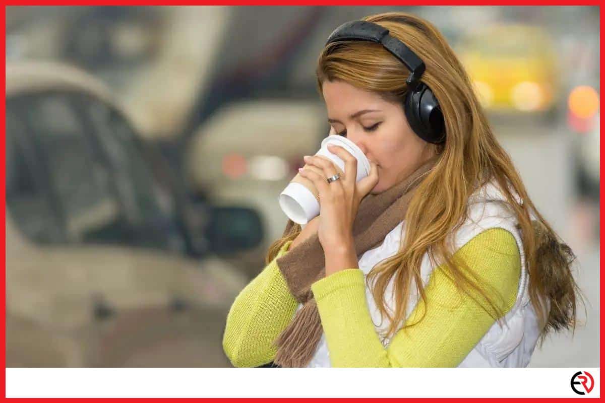 Woman listening with headphones in traffic