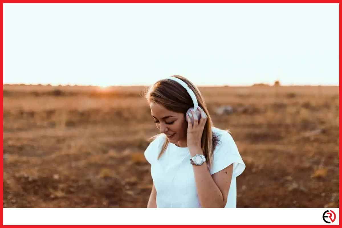 Woman listening to headphones outside